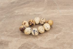 many of quail eggs on marble background